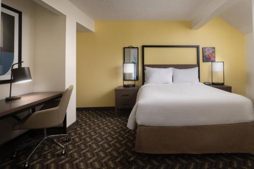 a hotel room with a bed and a desk and a computer at Residence Inn by Marriott San Francisco Airport San Mateo in San Mateo