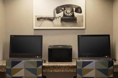 a room with two flat screens and a telephone at Residence Inn by Marriott San Francisco Airport San Mateo in San Mateo