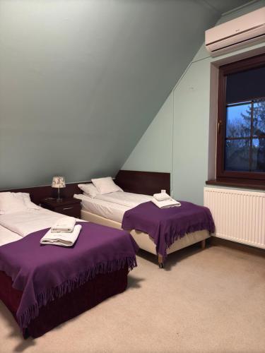 a room with two beds and a window at EdMar in Malbork