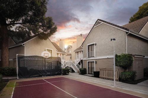 a tennis court in front of a house at Residence Inn by Marriott San Francisco Airport San Mateo in San Mateo