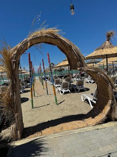 a beach with chairs and umbrellas on the sand at Comfort Suites in Golem