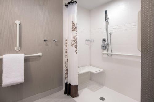 a bathroom with a shower and a toilet at Residence Inn by Marriott Boulder Canyon Boulevard in Boulder