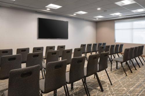 a conference room with a table and chairs and a screen at Residence Inn by Marriott Boulder Canyon Boulevard in Boulder