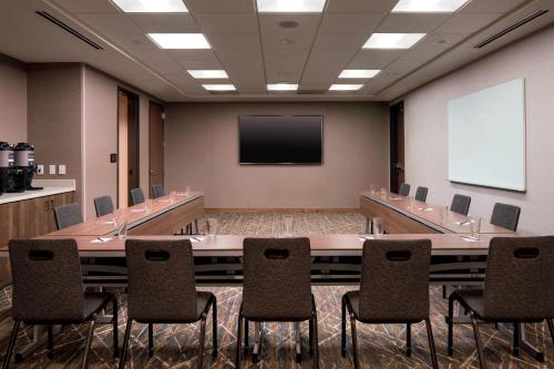 a conference room with a large table and chairs at Residence Inn by Marriott Boulder Canyon Boulevard in Boulder