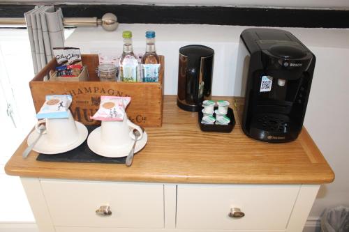 a wooden counter with a coffee maker and a coffee maker at The White Lion in Ventnor