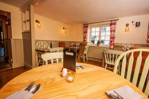 a room with a table with a cell phone on it at The White Lion in Ventnor