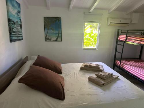 a bedroom with a bed with two bunk beds at Gwada Rêves in Sainte-Anne