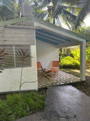 two chairs sitting on the patio of a house at Gwada Rêves in Sainte-Anne