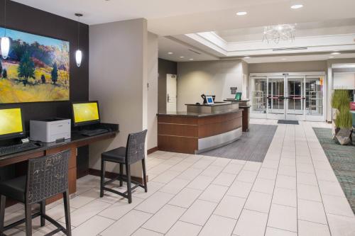 a lobby of a hospital with a reception desk and chairs at Residence Inn by Marriott Harrisonburg in Harrisonburg
