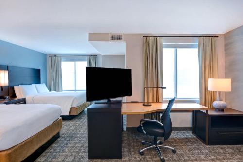 a hotel room with a desk and a bed and a television at Residence Inn by Marriott Fort Walton Beach in Fort Walton Beach