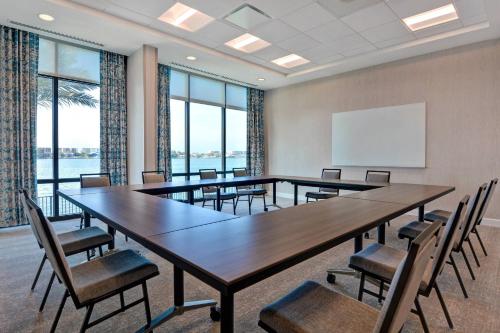 a conference room with tables and chairs and a whiteboard at Residence Inn by Marriott Fort Walton Beach in Fort Walton Beach