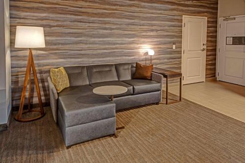 a living room with a couch and a table at Residence Inn by Marriott Tulsa Midtown in Tulsa