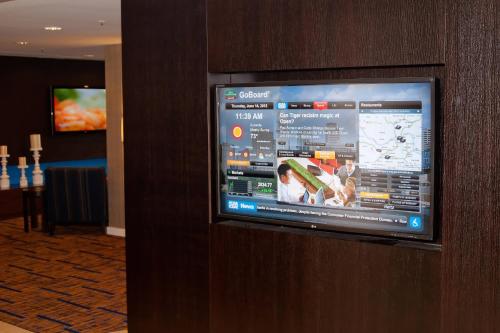 a television on a wall in a hotel room at Courtyard by Marriott Cincinnati Airport in Erlanger