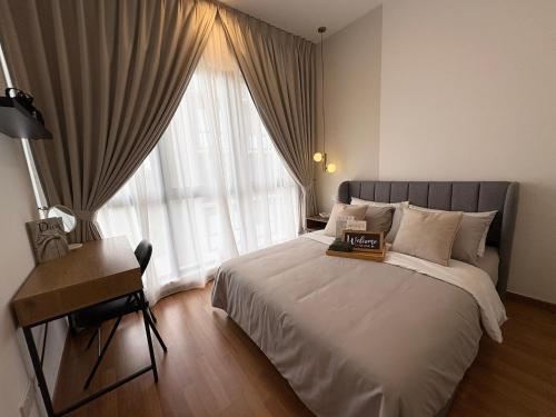 a bedroom with a bed and a desk and a window at Luxury Family Residence IOI Mall Putrajaya in Putrajaya
