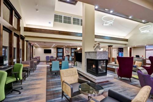 a lobby with chairs and a fireplace at Residence Inn by Marriott Hamilton in Hamilton