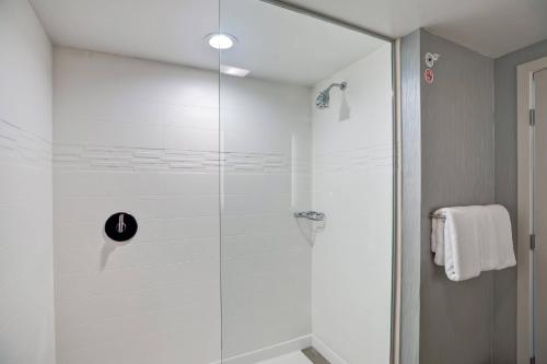 a shower with a glass door in a bathroom at Residence Inn by Marriott Hamilton in Hamilton