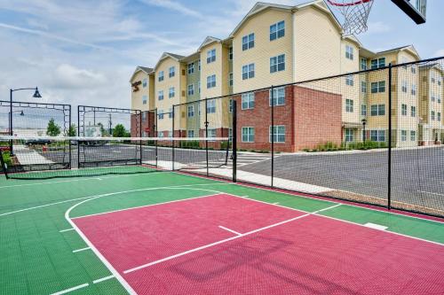a tennis court in front of a apartment building at Residence Inn by Marriott Hamilton in Hamilton
