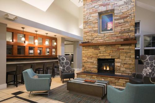 a lobby with a fireplace and a bar at Residence Inn by Marriott Salisbury in Salisbury