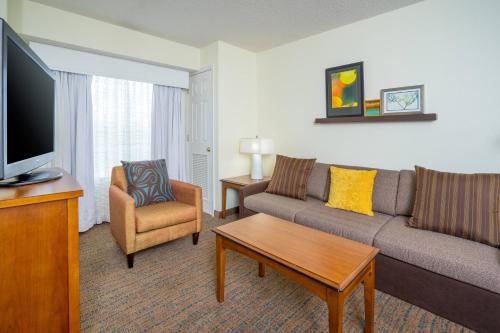 a living room with a couch and a tv at Residence Inn by Marriott Salisbury in Salisbury