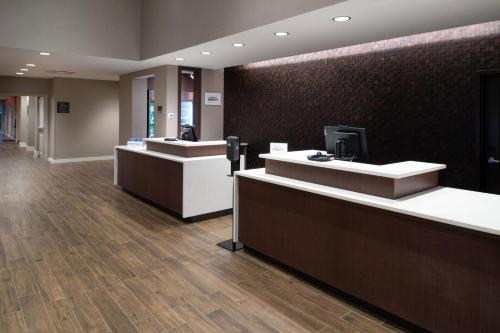 a lobby with two reception desks and a television at Residence Inn by Marriott St Louis Chesterfield in Chesterfield