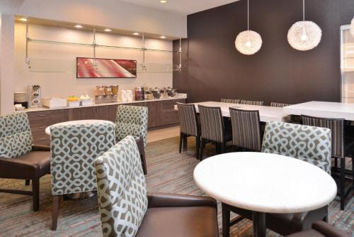 a restaurant with tables and chairs and a counter at Residence Inn by Marriott Branson in Branson