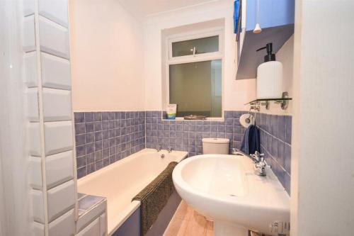 a bathroom with a white tub and a sink at The Bolt Hole in Brighton & Hove
