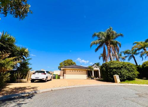 a white car parked in front of a house at Beautiful home Queen bed near train station in Cockburn Central