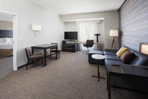 a hotel room with a couch and a bed at Residence Inn by Marriott Knoxville Downtown in Knoxville