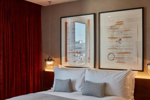 a bedroom with a bed with two pillows at Hotel Indigo London - 1 Leicester Square by IHG in London