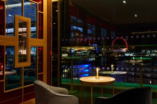 a table in a room with a view of a city at Hotel Indigo London - 1 Leicester Square by IHG in London