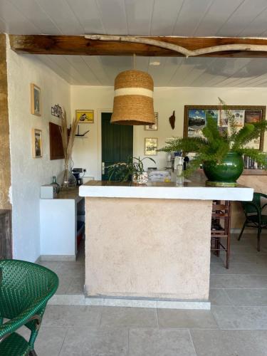 a kitchen with a island in the middle of a room at Le Râteau Bavoir in Calvi