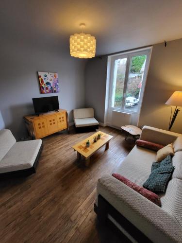 a living room with a couch and a coffee table at La Cigalienne in Treignac