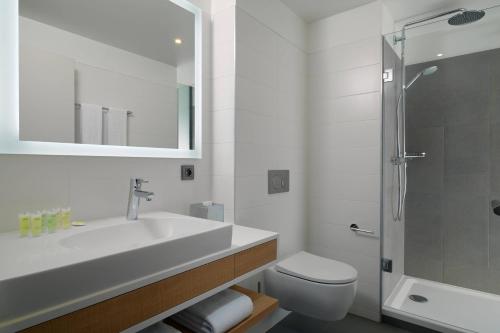a bathroom with a sink and a toilet and a shower at Residence Inn by Marriott Toulouse-Blagnac in Blagnac