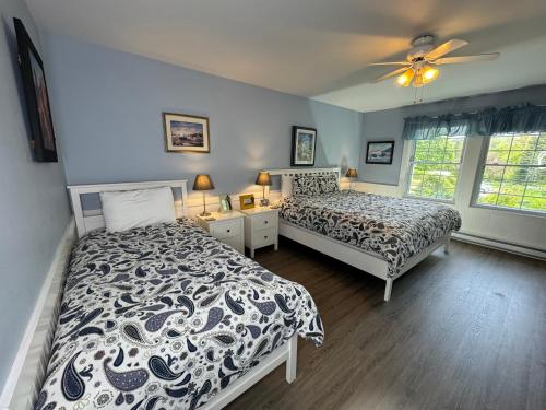 a bedroom with two beds and a ceiling fan at Gingerbread House Inn - We Are Open - Winter, Spring, Summer and Fall in Wolfville