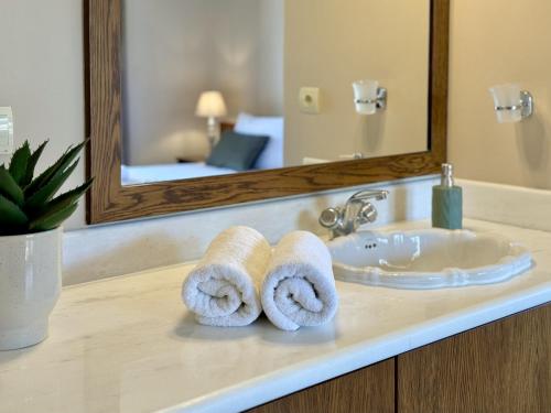 a bathroom with a sink and towels on a counter at Villa Metapothia Gavalochori Crete in Gavalochori