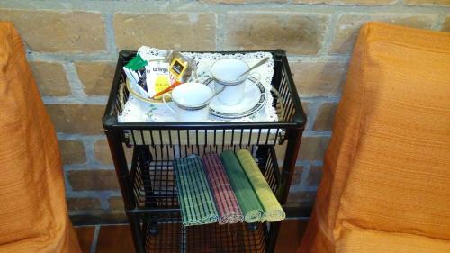 a shelf with a tea set and dishes on it at Casa 24 Puerto Iguazu in Puerto Iguazú