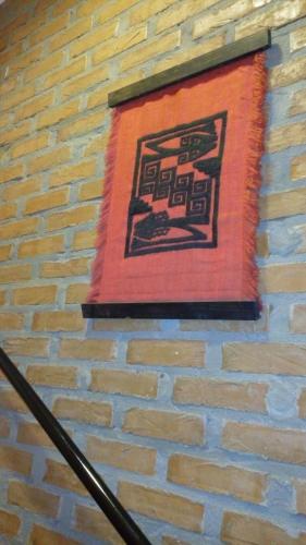 a painting on the side of a brick wall at Casa 24 Puerto Iguazu in Puerto Iguazú
