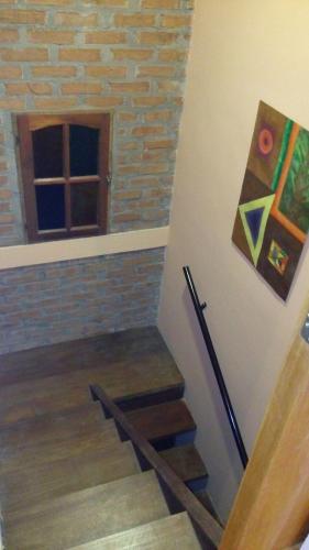 a staircase in a house with a painting on the wall at Casa 24 Puerto Iguazu in Puerto Iguazú
