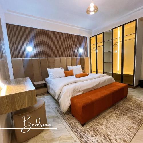 a bedroom with a large bed in a room at Desireé by StayHub - Luxury 3 Bedroom with PS5 in Jahi in Abuja