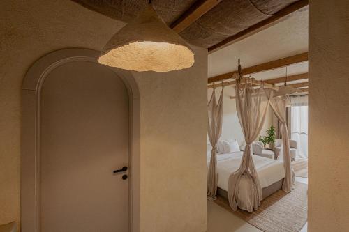a bedroom with a bed and a large window at Serab Residencia, Boutique Hotel & Resort in Al Kaslīk