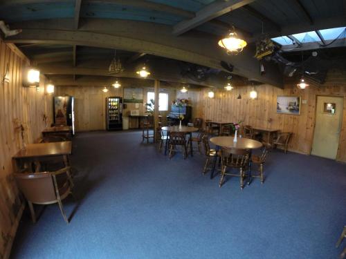 a room with tables and chairs in a building at High Seas Motel in Bar Harbor