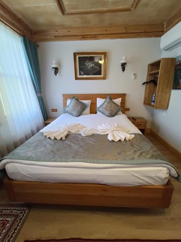 a bedroom with a large bed with towels on it at İstanbul Eagle's Nest Boutique Hotel in Istanbul