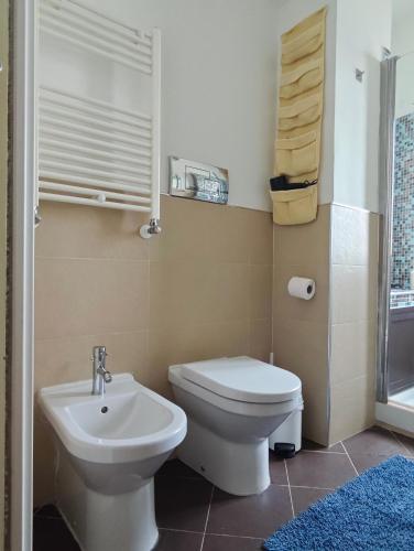a bathroom with a toilet and a sink at Il Balcone sul mare - free parking & relax in Palermo