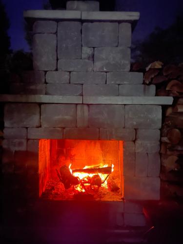 a brick oven with a fire in it at Gingerbread House Inn - We Are Open - Winter, Spring, Summer and Fall in Wolfville