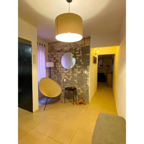 a living room with a chair and a lamp at Cozy Flat Condesa in Mexico City