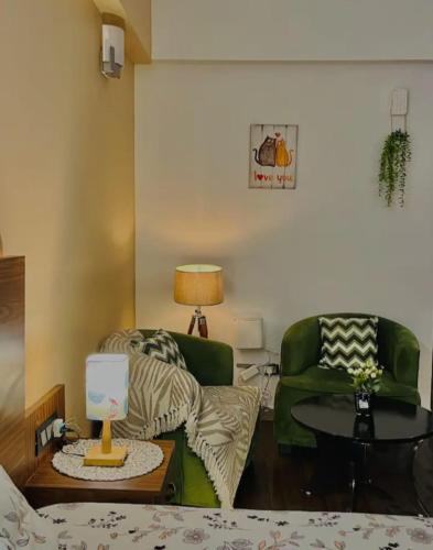a living room with a couch and a table at Liv box hotel in Rājpur