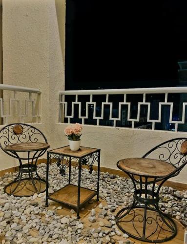 two chairs and a table in front of a stage at Liv box hotel in Rājpur