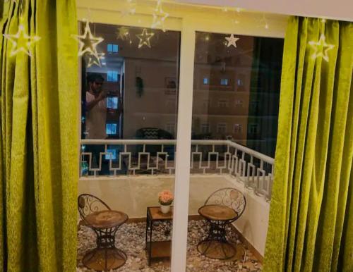 a view of a balcony with a table and chairs at Liv box hotel in Rājpur