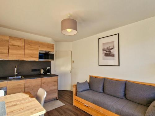 un salon avec un canapé et une table dans l'établissement Appartement lumineux avec balcon au centre de Flaine Forêt, parking disponible - FR-1-425-184, à Flaine