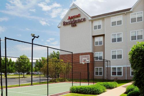 a tennis court in front of a hotel at Residence Inn Saint Louis Airport / Earth City in Earth City